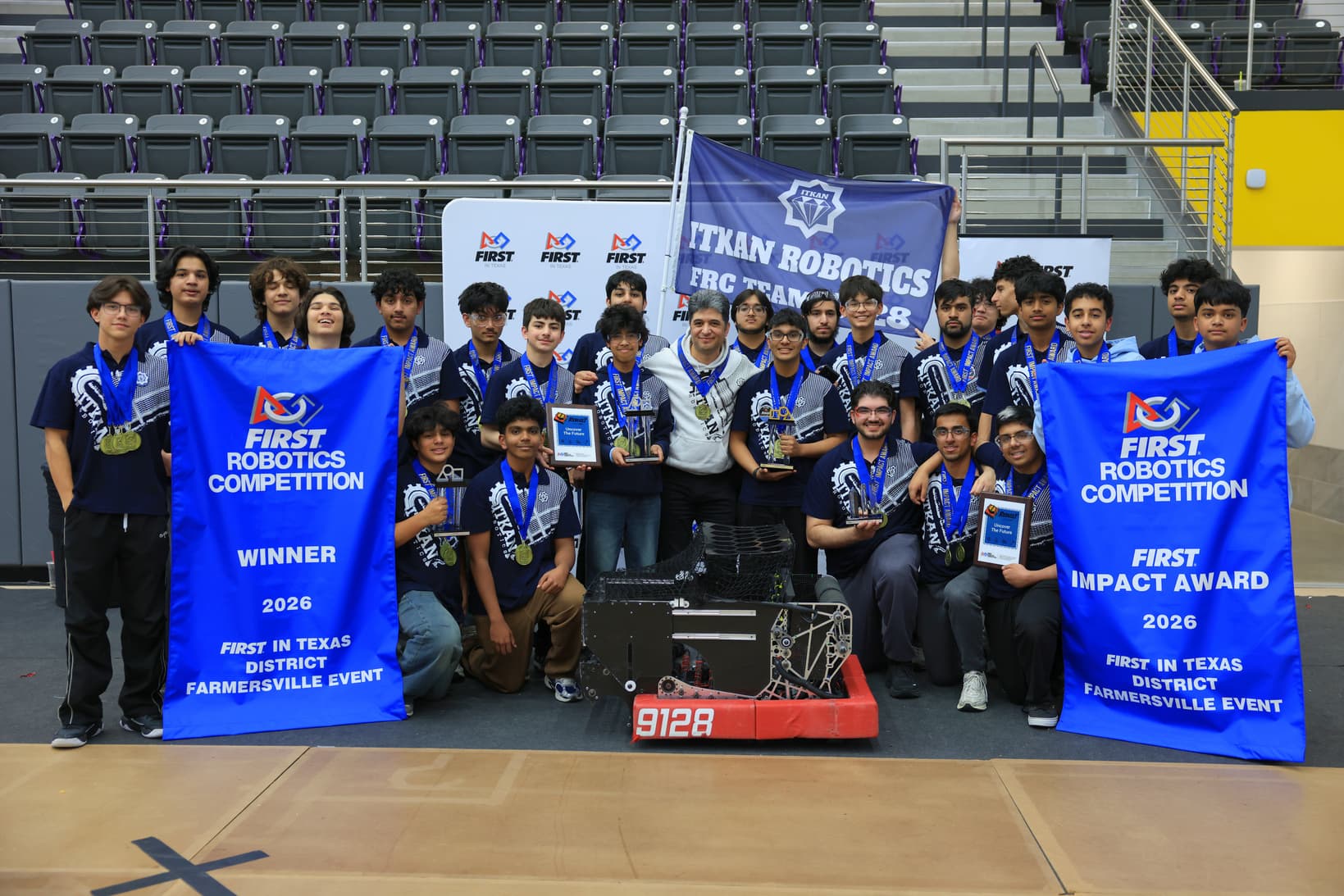 ITKAN FRC team carrying their robot at the Farmersville District Event