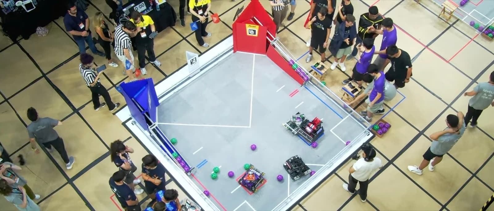 An overhead view of an FTC match in progress at the Istanbul Premier Event, with robots on the field and drive teams at the alliance stations