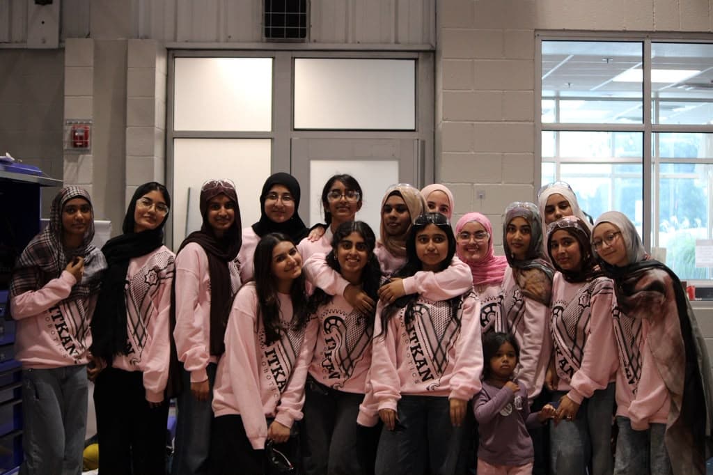 ITKAN Girls FRC Team 10340 in matching pink ITKAN hoodies, posing together at STEM GALS 2026