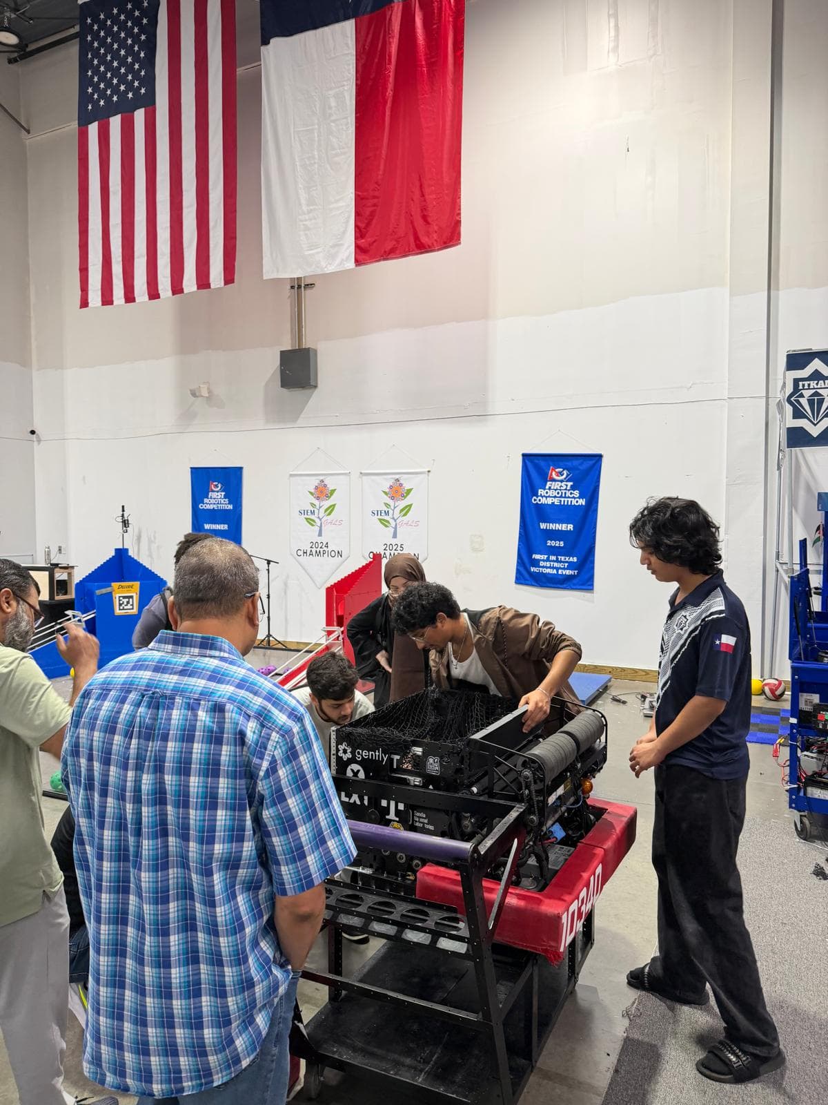 A Texas Instruments engineer reviews the robot's electrical system with an ITKAN student
